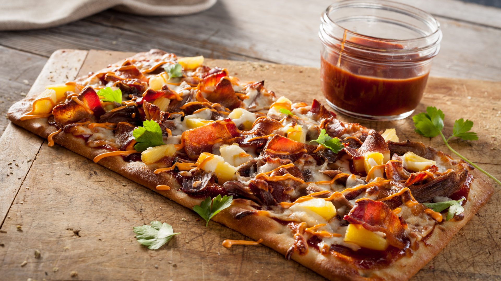 Stonefire Flatbread topped with bbq pulled pork, pineapple, cheese and cilantro.