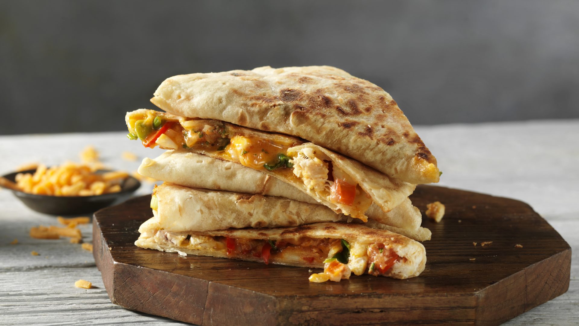 Breakfast Quesadilla stuffed with fried egg, chicken, cheese, tomatoes and chives using Stonefire Piadina.